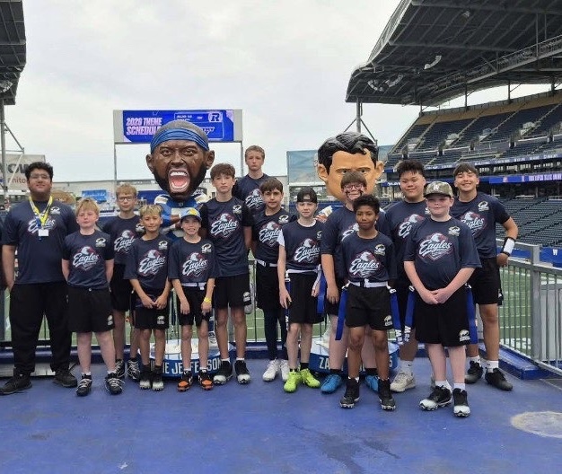 Royals youth players posing together in team shirts at the stadium