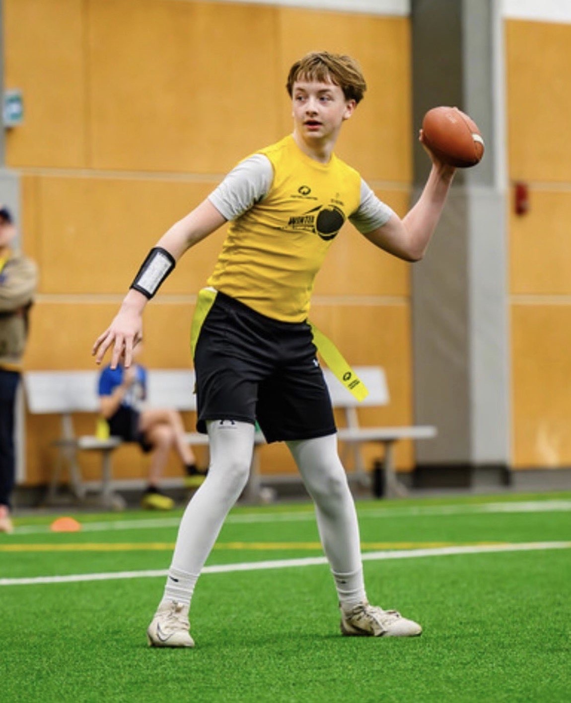 Royals quarterback throwing a pass on indoor turf